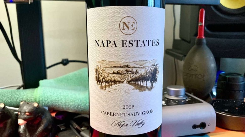 Napa Estates wine label with assorted camera equipment in the background.