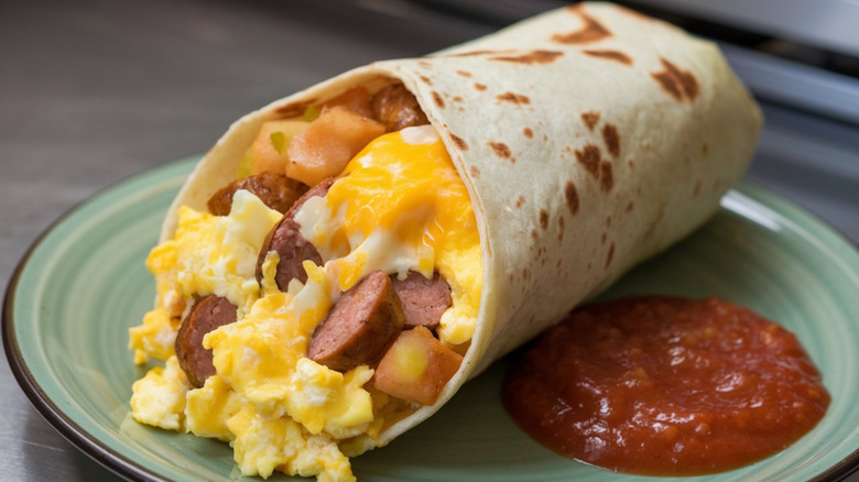 A breakfast burrito with salsa