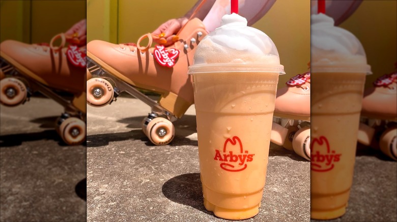 Arby's Orange Cream Shake next to a roller skate