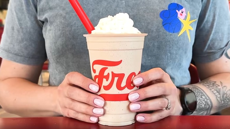 Woman holding a Freddy's Dr Pepper Frost