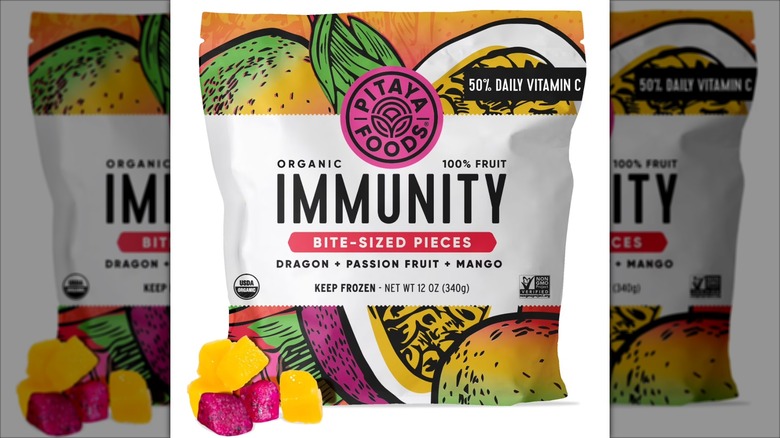A closeup photo of the package for Pitaya Foods Bite-Sized Immunity Frozen Fruit Blend against a mirrored background