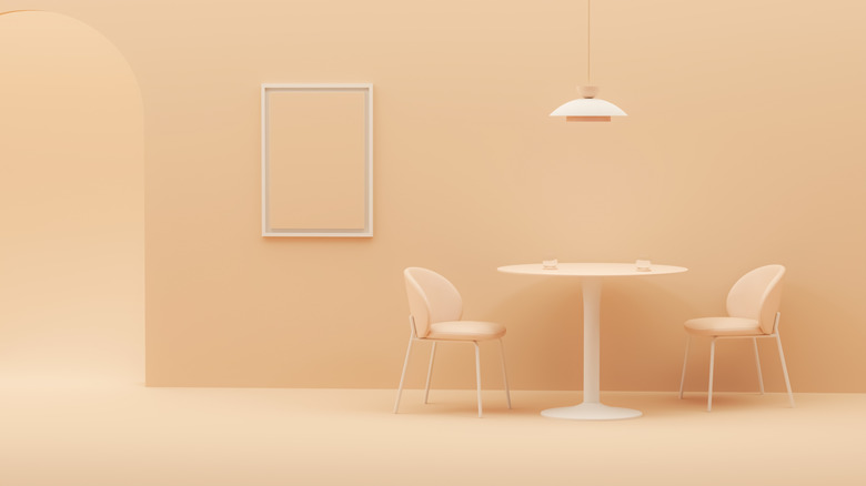 A peach colored room with a matching peach set of table and chairs