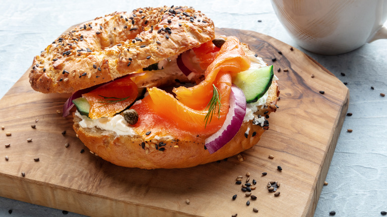 Everything bagel with salmon, cream cheese, and onions