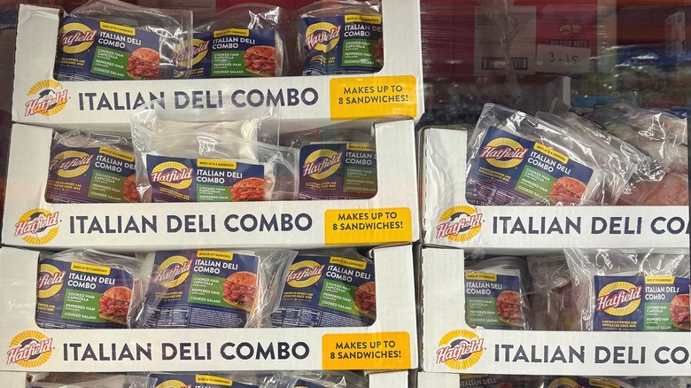 Packages of Costco deli meats in stacked boxes