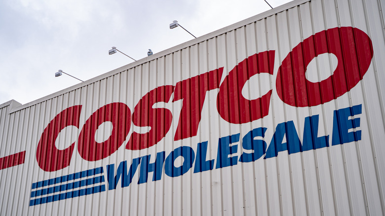 A close-up of the Costco Wholesale sign on a warehouse building