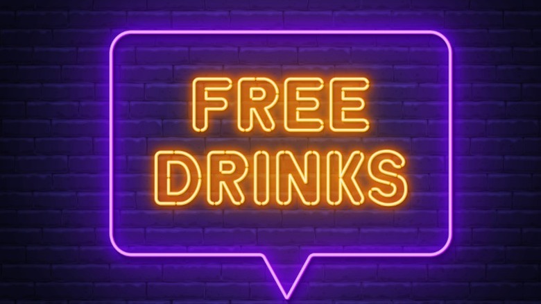 free drinks sign in purple and yellow neon