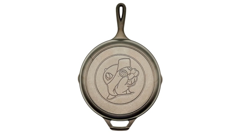 A cast iron skillet with the Buc-ee's logo on it against a white background