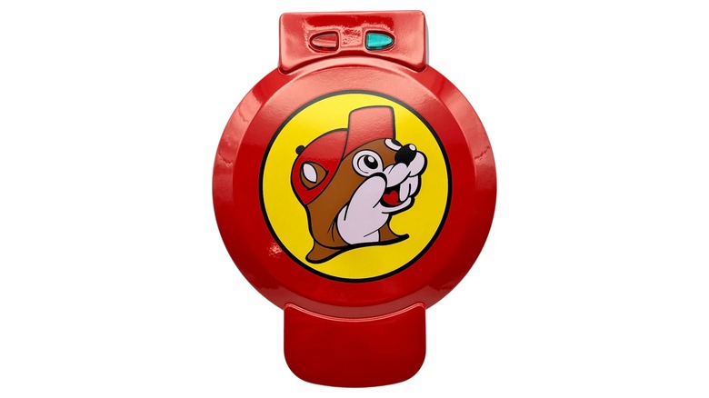 A red waffle maker with the Buc-ee's logo on it against a white background