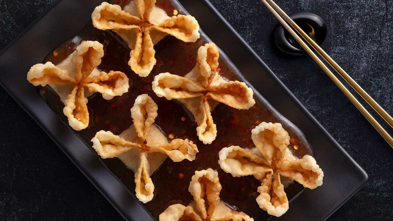An overhead photo of a plate with six P.F. Chang's Hand-Folded Crab Wontons