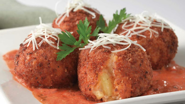 Fried Macaroni and Cheese from The Cheesecake Factory served on a white plate with marinara sauce