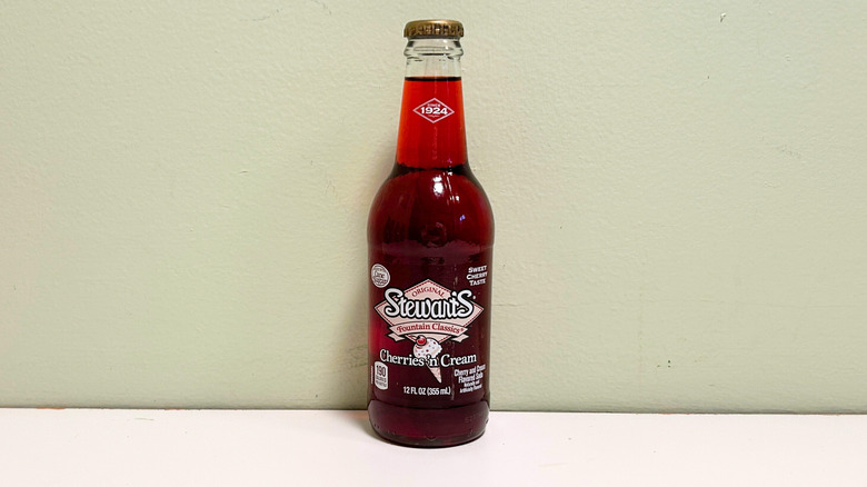 A glass bottle of Stewarts Cherries n' Cream Soda