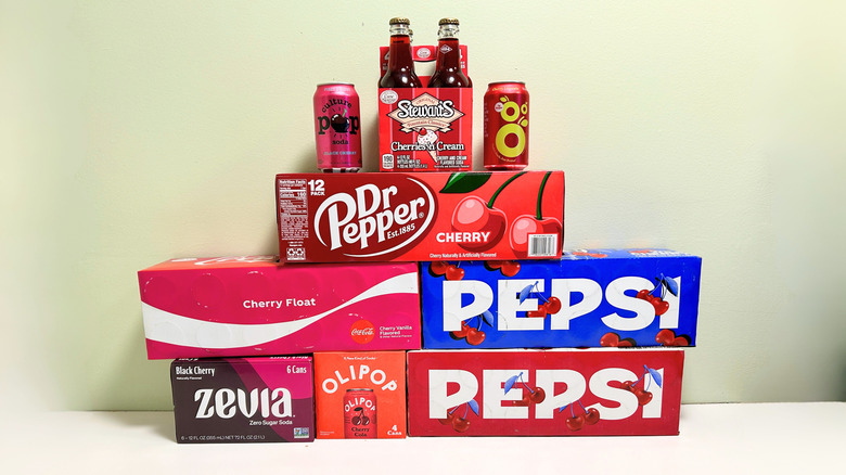 Several boxes, cans, and containers of unopened cherry sodas