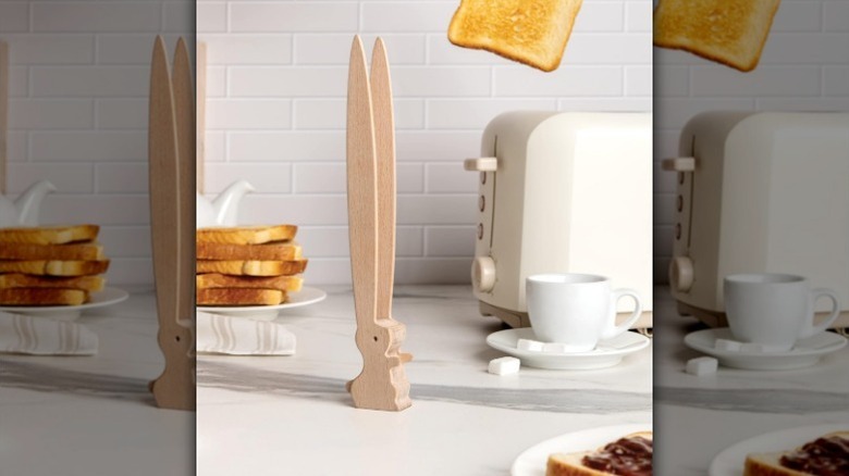 Toaster tongs sit on counter next to toaster