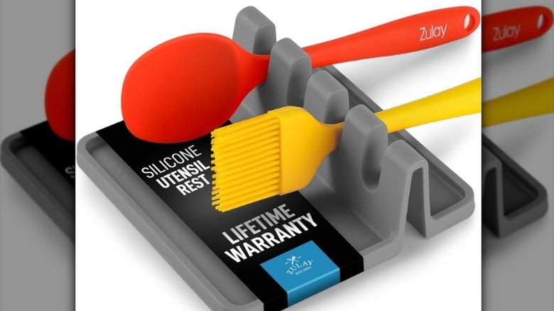 Spoon rest on white background with utensils