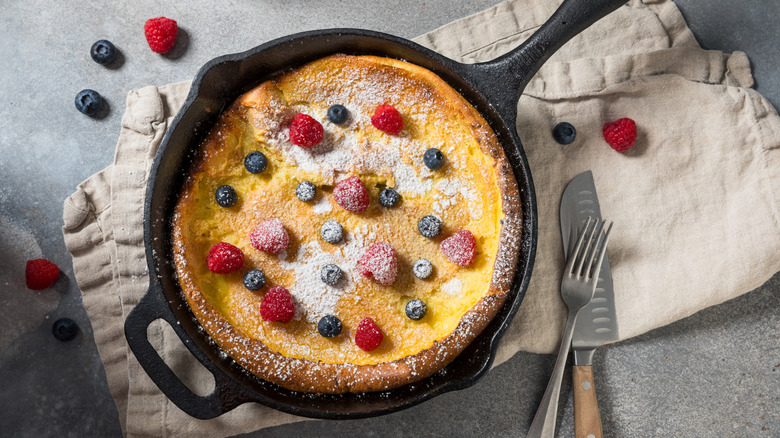 An overhead view of a Dutch Baby in a cast-iron skillet