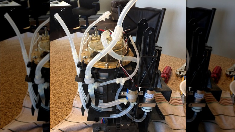Keurig machine disassembled on towel with plastic tubing revealed