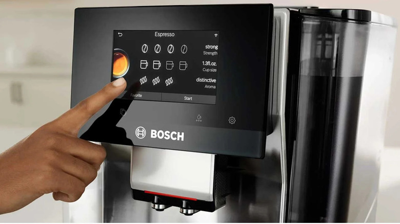 finger using touch screen to operate bosch coffee machine