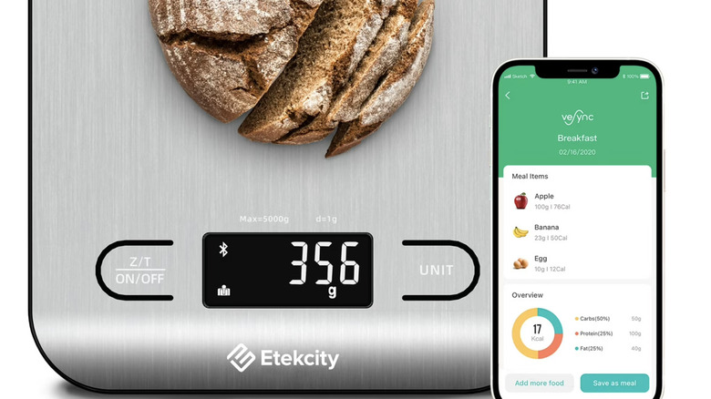 sliced rustic bread being weighed on kitchen Etekcity scale using an app
