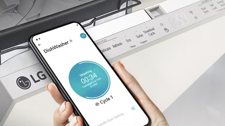 hand holding phone displaying LG app near the LG dishwasher control panel