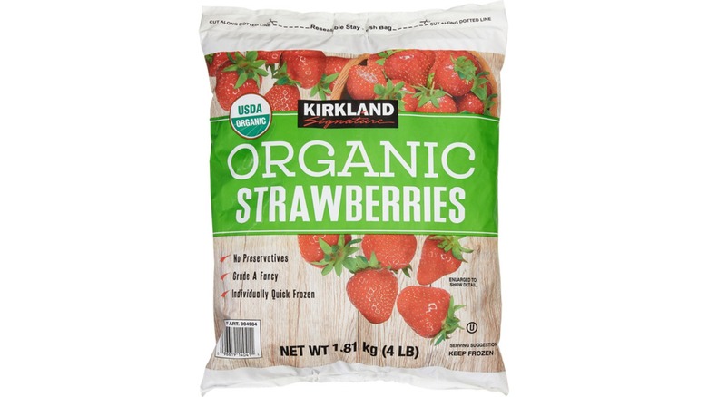 Bag of Kirkland Signature Organic Strawberries against white background.