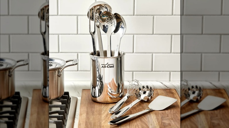 The All-Clad 8-piece Kitchen Utensil Set, with three utensils on a cutting board