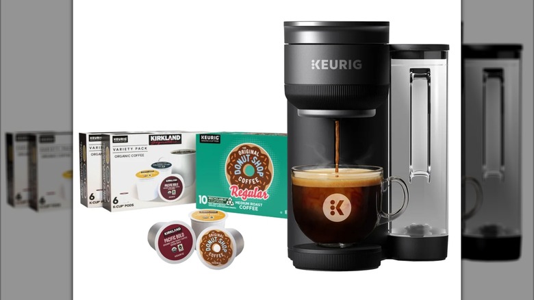 A Keurig K-Crema coffee maker with three boxes of complimentary coffee pods