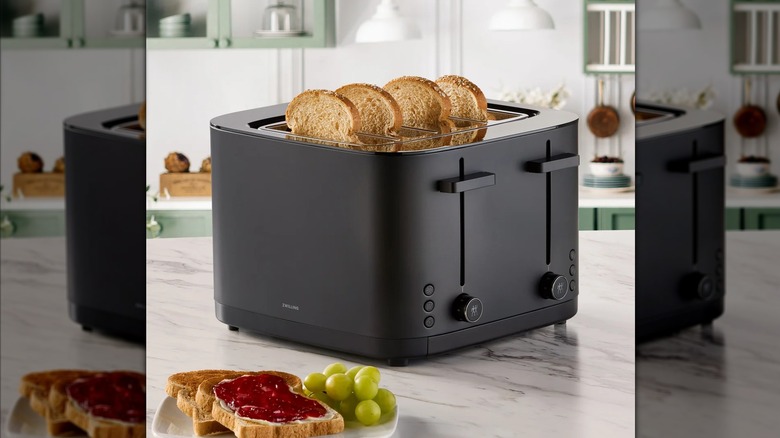 A black Zwilling Enfinigy 4-slice Toaster making toast
