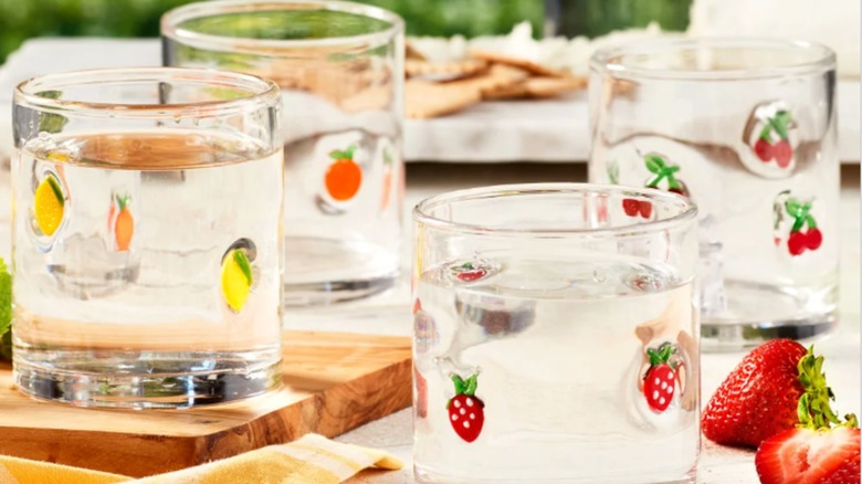 Costco Pandex 14 oz. Icon Glasses filled with clear liquids on a table next to strawberries