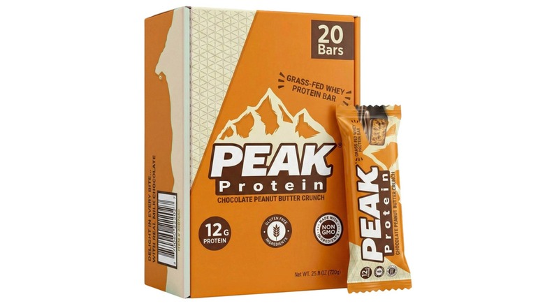 Box of Peak Protein Chocolate Peanut Butter Crunch Protein Bars with an individual bar