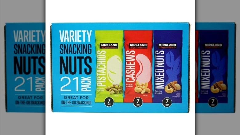 Variety of snacking nuts on white background