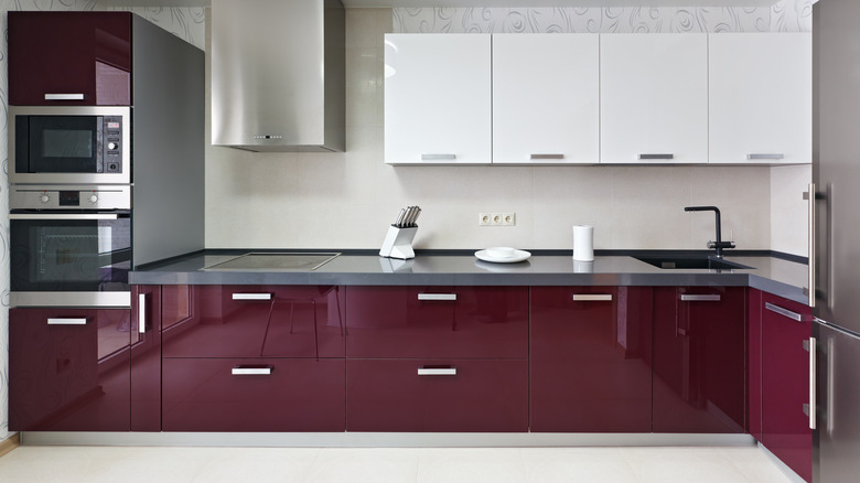 Modernist kitchen with shiny purple cabinets