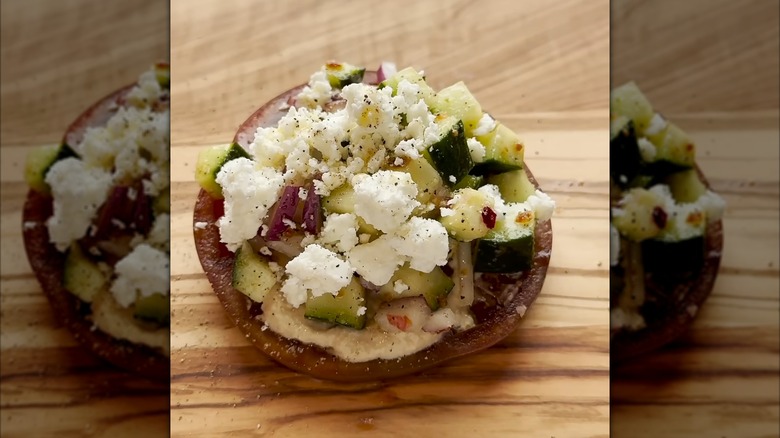 Mediterranean-style tomato on a wood serving board