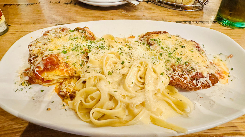 A large plate of pasta and meat at Olive Garden