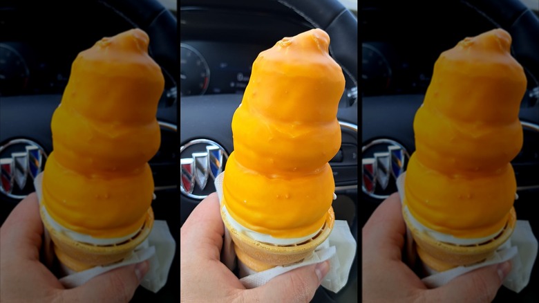 Hand holding butterscotch-dipped cone