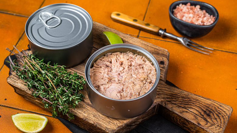 tuna cans on wooden board