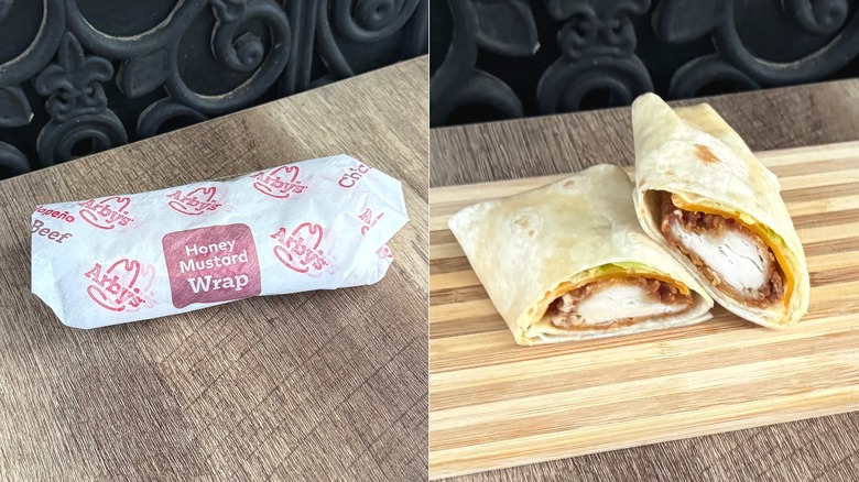 Arby's Honey Mustard wrap, in its packaging and sliced in half to show the filling
