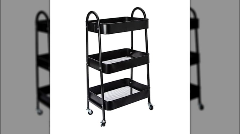 A three-shelf rolling cart made of black metal