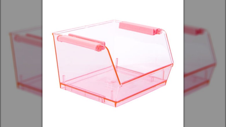 A clear pink plastic organizing bin, with an open front and top