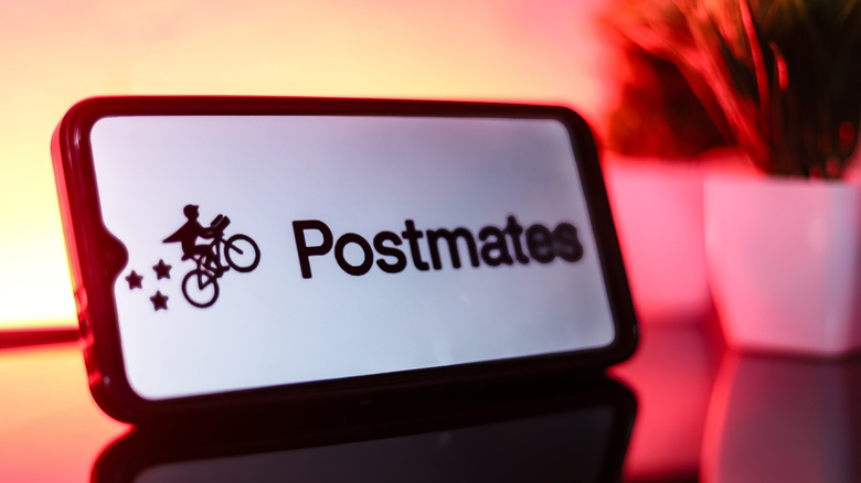A closeup on a Postmates iPad with the company's logo on it