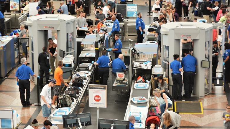 travelers going through airport security
