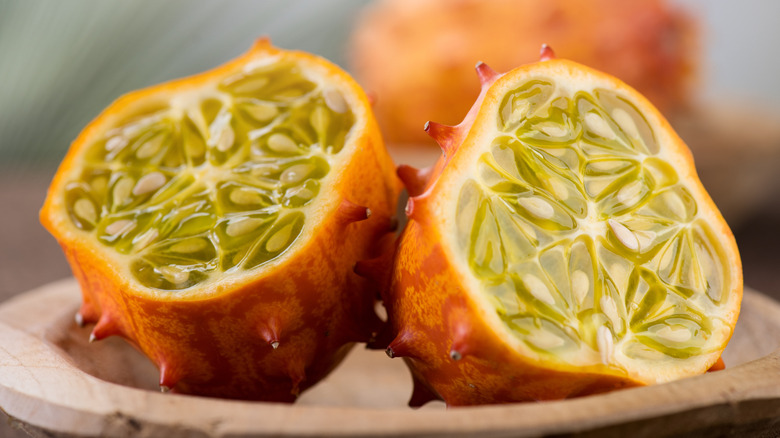 A horned melon, sliced in half