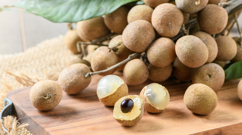 Longan fruit on a wooden chopping board