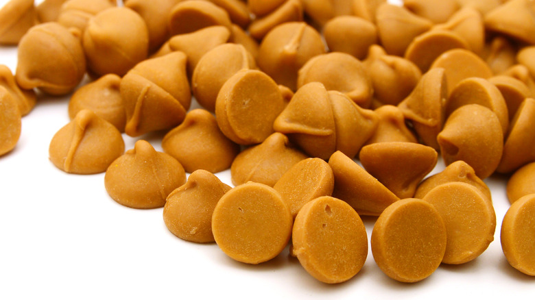Closeup of butterscotch chips on white surface