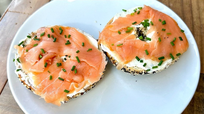 Two bagel halves topped with cream cheese and smoked salmon