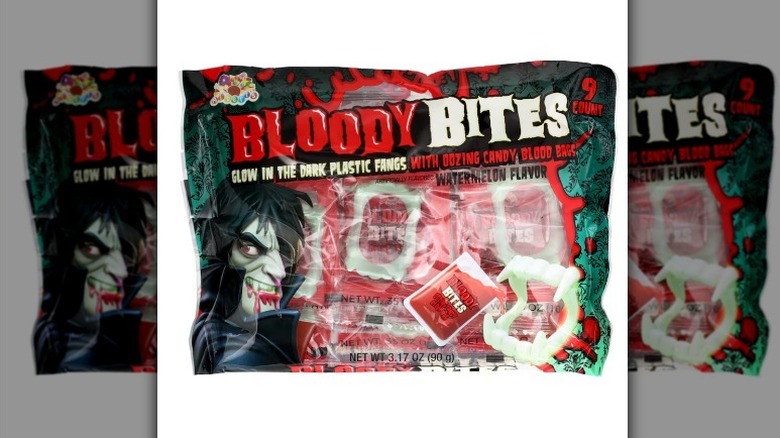 Bloody Bites fangs with candy blood on a white background