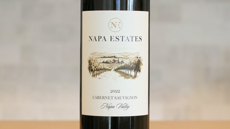 A close up of a Napa Estates Cabernet Sauvignon bottle and label on table
