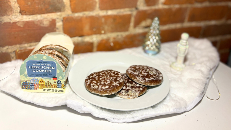 A plate of Lebkuchen cookies next to a box against a brick background