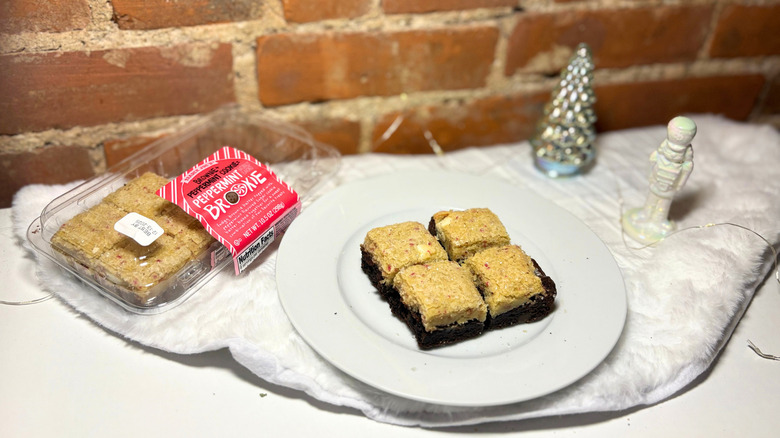 A plate of brookies next to a box against a brick background