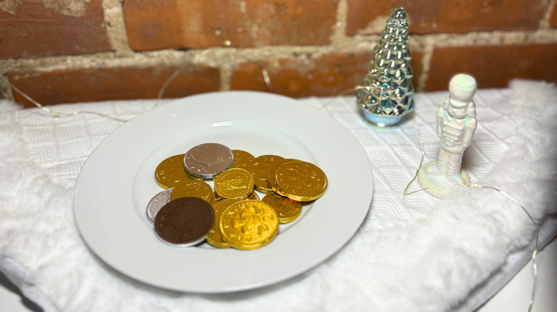 A plate of coins against a brick background