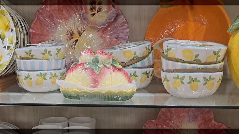 Three stacks of three bowls with blue stripes and lemon designs on a HomeGoods shelf